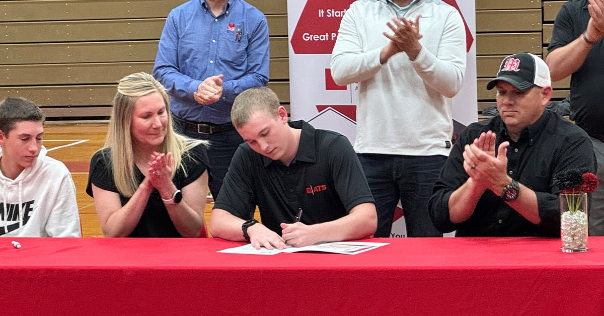 Metamora high school student signs ATS offer letter with family and friends.